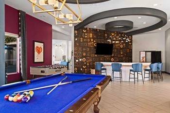 Resident clubhouse featuring billiards, retro arcade games, a photobooth, and stylish entertaining space